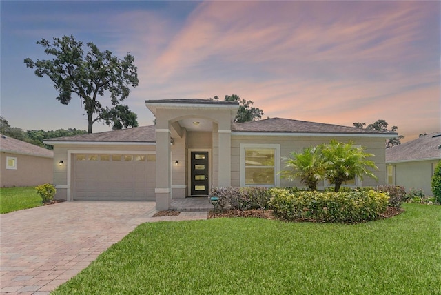 1812 Stoneywood Way, Apopka, FL 32712 - view of front of property featuring decorative driveway, an attached garage, and a lawn