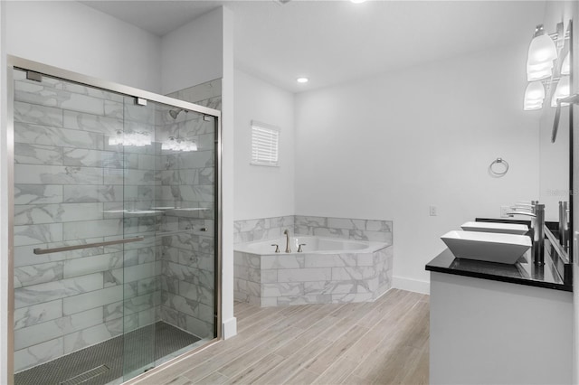1812 Stoneywood Way, Apopka, FL 32712 - full bathroom with a garden tub, a stall shower, double vanity, wood finished floors, and recessed lighting