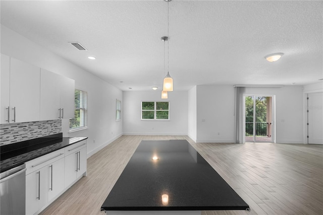 1812 Stoneywood Way, Apopka, FL 32712 - unfurnished dining area with a textured ceiling, light wood finished floors, baseboards, and recessed lighting