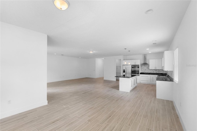 1812 Stoneywood Way, Apopka, FL 32712 - kitchen with stainless steel refrigerator with ice dispenser, dark countertops, a sink, wall chimney range hood, and baseboards
