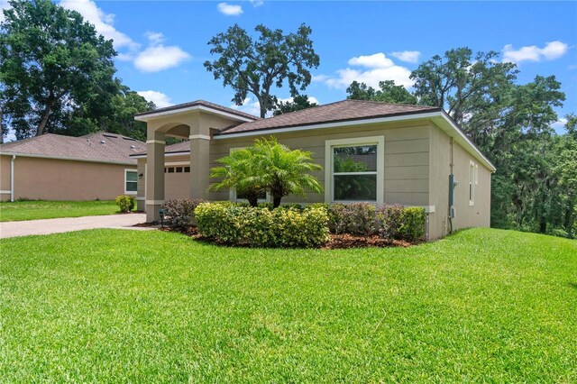 1812 Stoneywood Way, Apopka, FL 32712 - view of front of house featuring a front lawn, driveway, and an attached garage