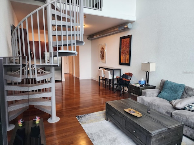 150 E Robinson St Unit 419, Orlando, FL 32801 - living room featuring stairway, wood finished floors, and baseboards