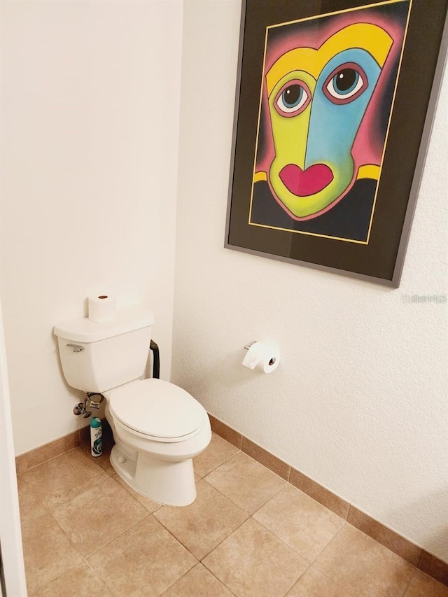 150 E Robinson St Unit 419, Orlando, FL 32801 - bathroom with toilet, baseboards, and tile patterned flooring