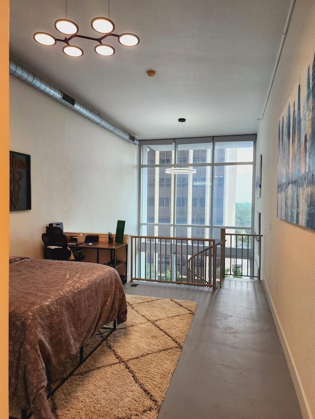 150 E Robinson St Unit 419, Orlando, FL 32801 - bedroom with concrete flooring, expansive windows, an office area, and baseboards