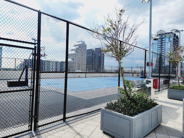 150 E Robinson St Unit 419, Orlando, FL 32801 - view of tennis court featuring a city view and a gate