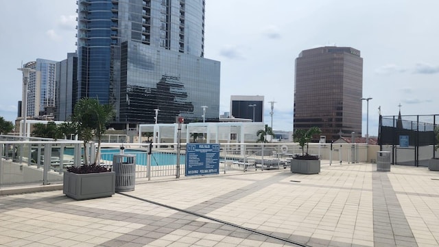 150 E Robinson St Unit 419, Orlando, FL 32801 - view of patio featuring a community pool, central AC unit, and a view of city