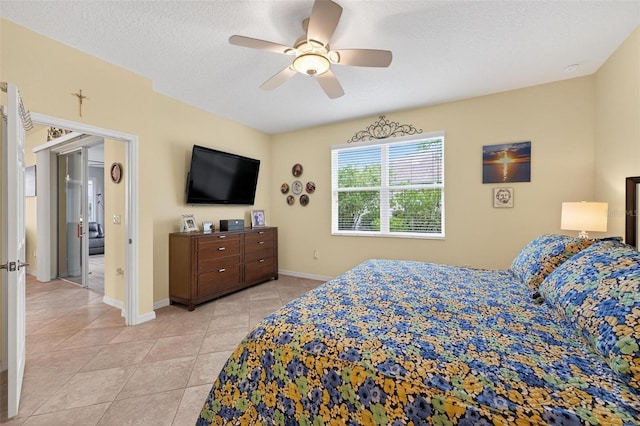 8336 SW 77th Ct, Ocala, FL 34476 - bedroom featuring light tile patterned floors, ceiling fan, baseboards, and a textured ceiling