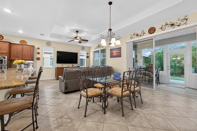8336 SW 77th Ct, Ocala, FL 34476 - dining space featuring a tray ceiling, light tile patterned floors, ceiling fan, crown molding, and a chandelier