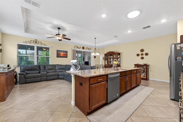 8336 SW 77th Ct, Ocala, FL 34476 - kitchen with stainless steel appliances, a sink, light tile patterned flooring, a raised ceiling, and ceiling fan