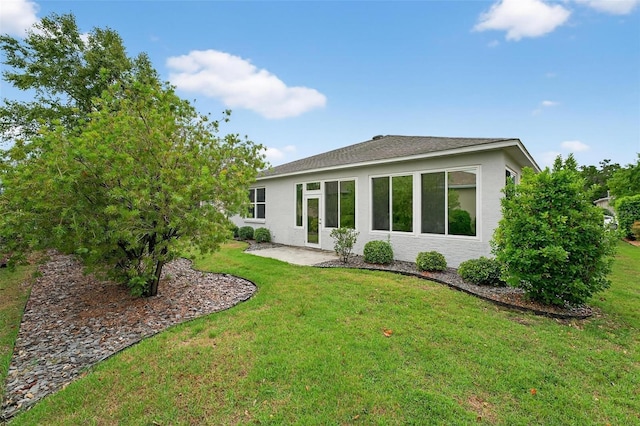 8336 SW 77th Ct, Ocala, FL 34476 - rear view of property with stucco siding and a yard