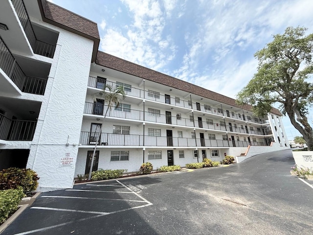 118 S Halifax Ave Unit 409, Daytona Beach, FL 32118 - view of apartment building / complex featuring uncovered parking