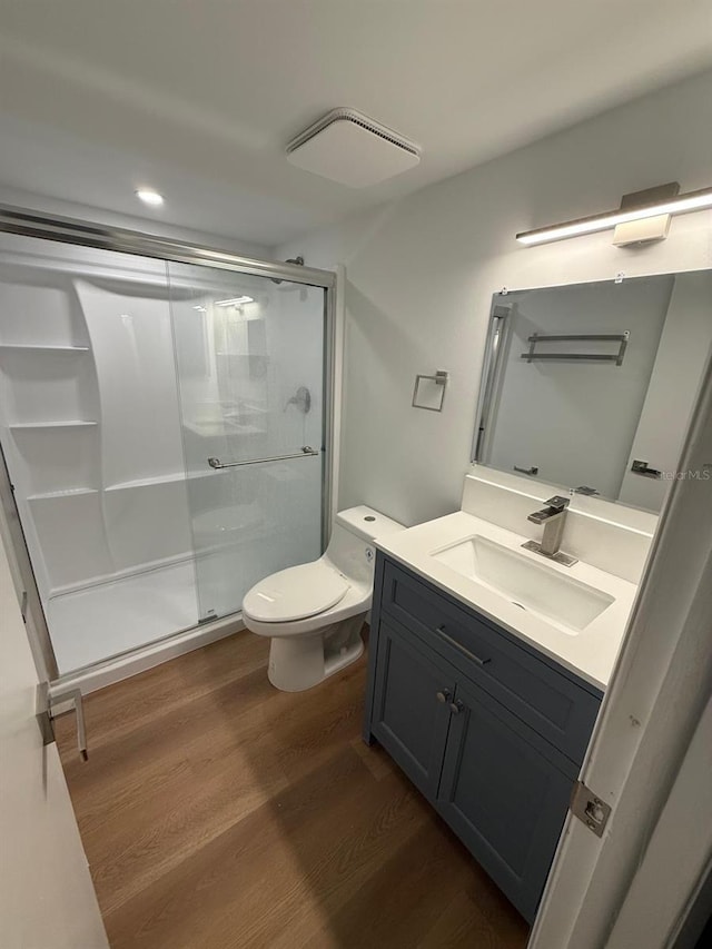 118 S Halifax Ave Unit 409, Daytona Beach, FL 32118 - full bath featuring wood finished floors, toilet, vanity, a shower stall, and recessed lighting
