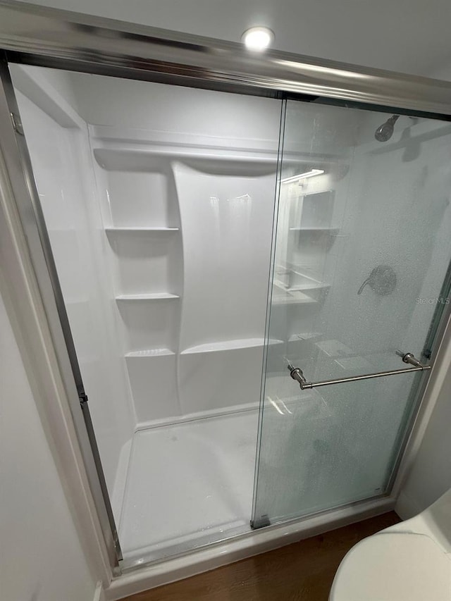 118 S Halifax Ave Unit 409, Daytona Beach, FL 32118 - bathroom featuring a stall shower and toilet