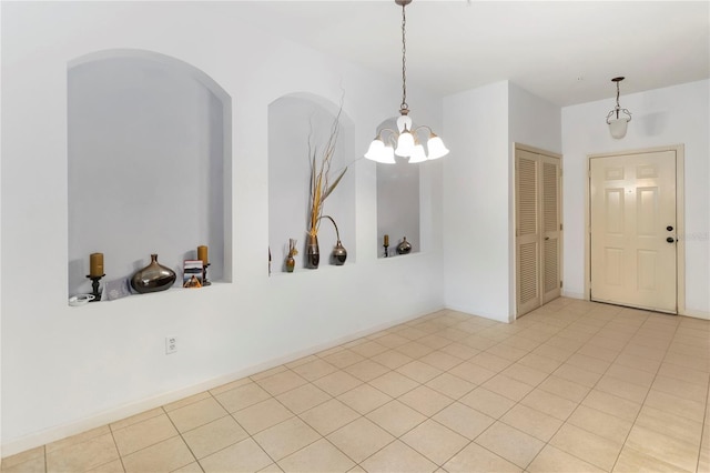 3000 Laurel Park Ln Unit 308, Kissimmee, FL 34741 - spare room with a chandelier, tile patterned flooring, and arched walkways