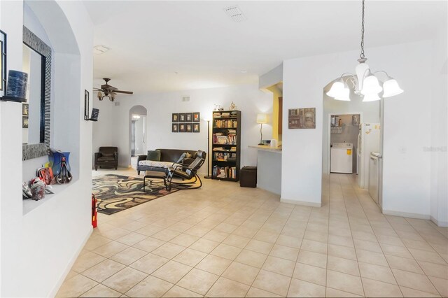 3000 Laurel Park Ln Unit 308, Kissimmee, FL 34741 - living area with arched walkways, a ceiling fan, a chandelier, and light tile patterned floors