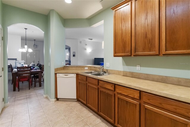 3000 Laurel Park Ln Unit 308, Kissimmee, FL 34741 - kitchen with white dishwasher, a sink, light tile patterned flooring, arched walkways, and light countertops