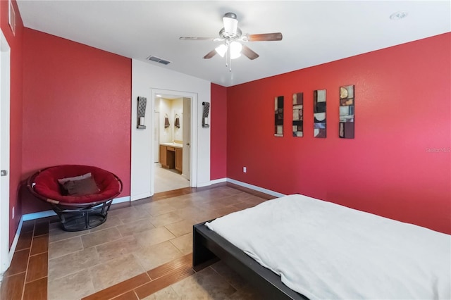 3000 Laurel Park Ln Unit 308, Kissimmee, FL 34741 - bedroom featuring a ceiling fan, connected bathroom, tile patterned floors, and baseboards