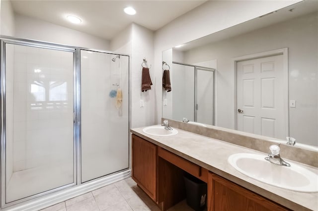 3000 Laurel Park Ln Unit 308, Kissimmee, FL 34741 - bathroom featuring a shower stall, double vanity, and tile patterned flooring