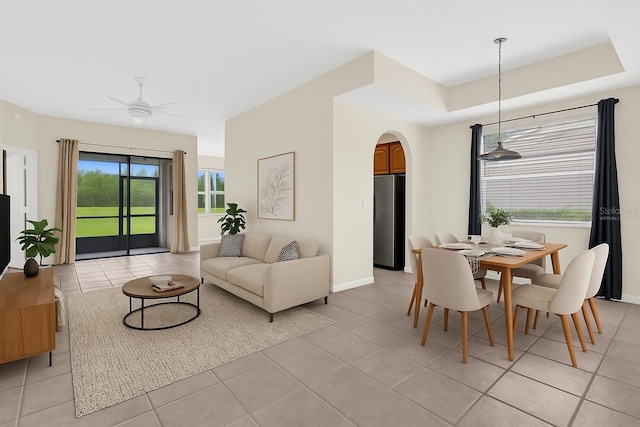 9435 Myrtle Creek Ln Unit 308, Orlando, FL 32832 - dining room with arched walkways, light tile patterned flooring, a ceiling fan, and baseboards