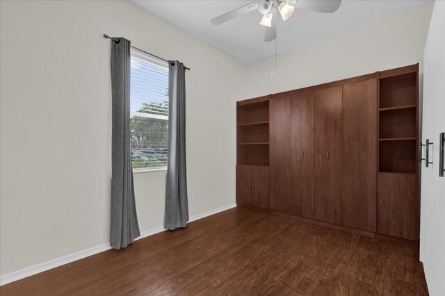 9435 Myrtle Creek Ln Unit 308, Orlando, FL 32832 - unfurnished bedroom with dark wood-type flooring, baseboards, ceiling fan, and a closet