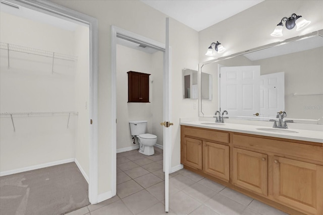 9435 Myrtle Creek Ln Unit 308, Orlando, FL 32832 - full bathroom featuring double vanity, toilet, tile patterned floors, and a spacious closet