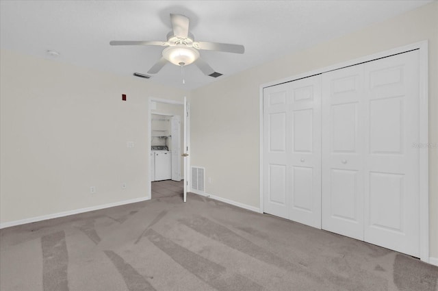 9435 Myrtle Creek Ln Unit 308, Orlando, FL 32832 - unfurnished bedroom with washing machine and clothes dryer, carpet flooring, a closet, baseboards, and ceiling fan
