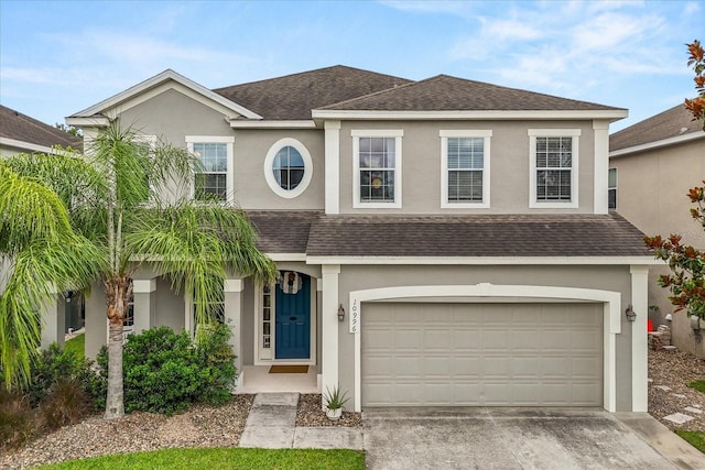 10996 Inside Loop, Orlando, FL 32825 - traditional-style home with stucco siding, roof with shingles, a garage, and driveway