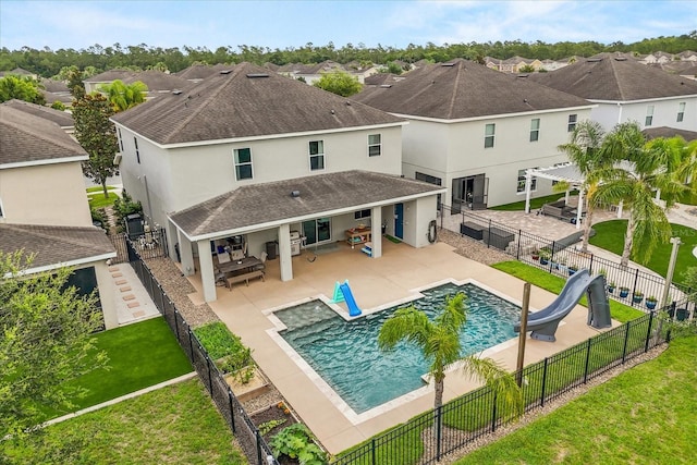 10996 Inside Loop, Orlando, FL 32825 - rear view of house featuring roof with shingles, stucco siding, a fenced backyard, a patio, and a residential view