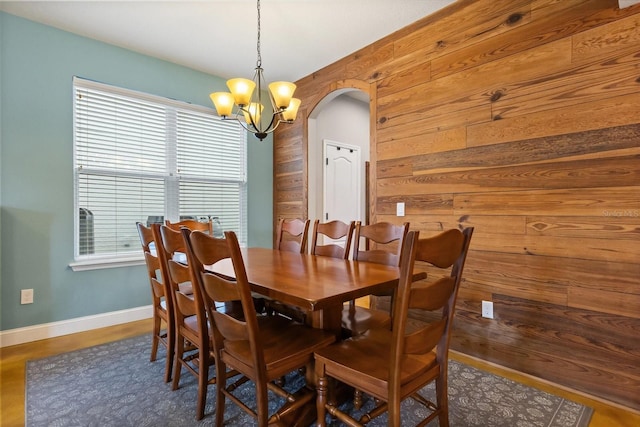 10996 Inside Loop, Orlando, FL 32825 - dining room with arched walkways, wooden walls, and a chandelier