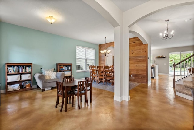 10996 Inside Loop, Orlando, FL 32825 - dining space with a chandelier, finished concrete flooring, stairs, and arched walkways