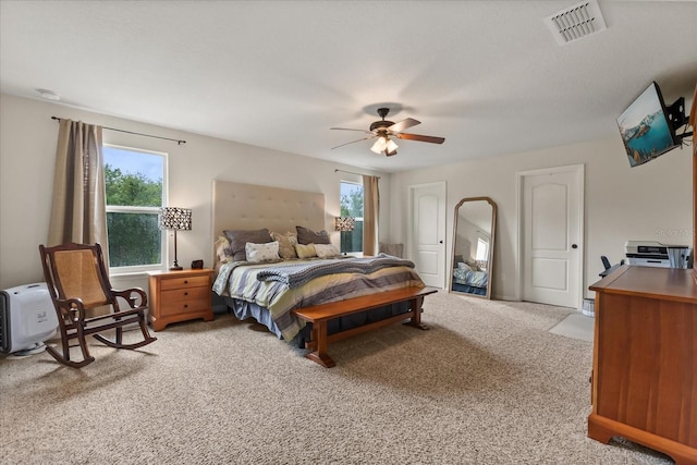 10996 Inside Loop, Orlando, FL 32825 - carpeted bedroom with multiple windows and a ceiling fan