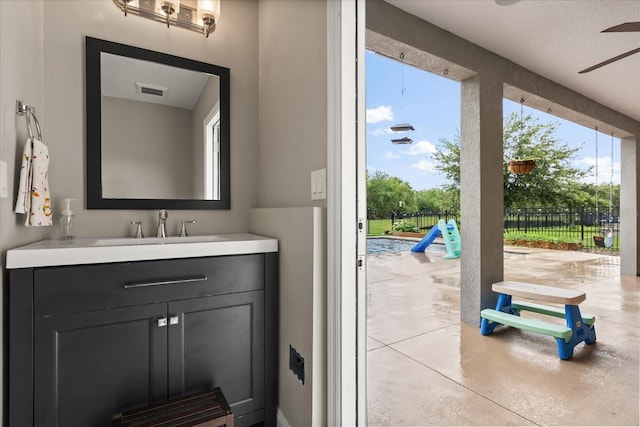 10996 Inside Loop, Orlando, FL 32825 - bathroom with vanity, a ceiling fan, and finished concrete flooring