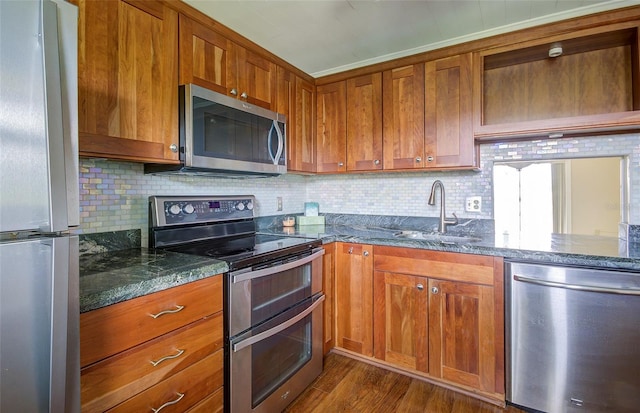 2615 NE 3rd Ct Unit 416, Boynton Beach, FL 33435 - kitchen with appliances with stainless steel finishes, a sink, brown cabinetry, and decorative backsplash