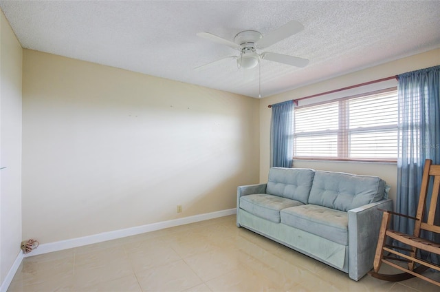 2615 NE 3rd Ct Unit 416, Boynton Beach, FL 33435 - sitting room featuring a textured ceiling, a ceiling fan, and baseboards