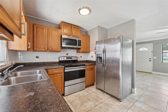 510 Peach Tree Ln, Altamonte Springs, FL 32701 - kitchen featuring appliances with stainless steel finishes, tasteful backsplash, crown molding, light tile patterned flooring, and dark countertops
