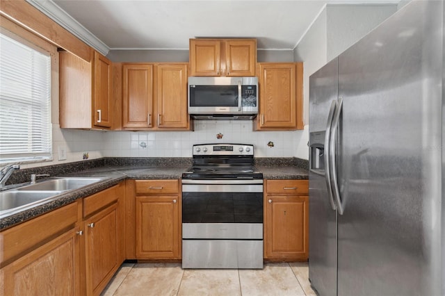 510 Peach Tree Ln, Altamonte Springs, FL 32701 - kitchen featuring appliances with stainless steel finishes, crown molding, dark countertops, light tile patterned flooring, and tasteful backsplash