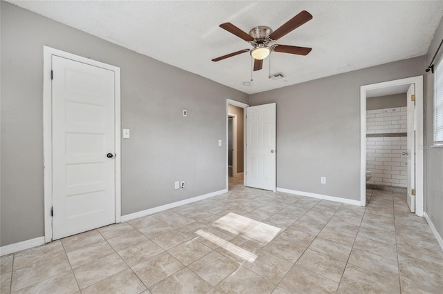 510 Peach Tree Ln, Altamonte Springs, FL 32701 - unfurnished bedroom featuring light tile patterned flooring, ensuite bathroom, a ceiling fan, and a textured ceiling