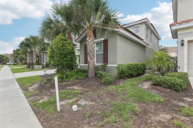 7033 Oakwood St, Davenport, FL 33837 - view of property exterior featuring stucco siding