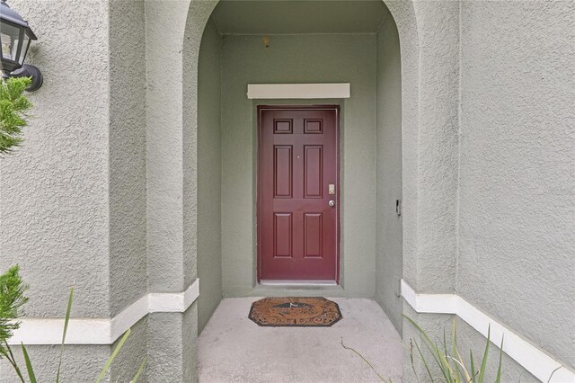 7033 Oakwood St, Davenport, FL 33837 - property entrance with stucco siding