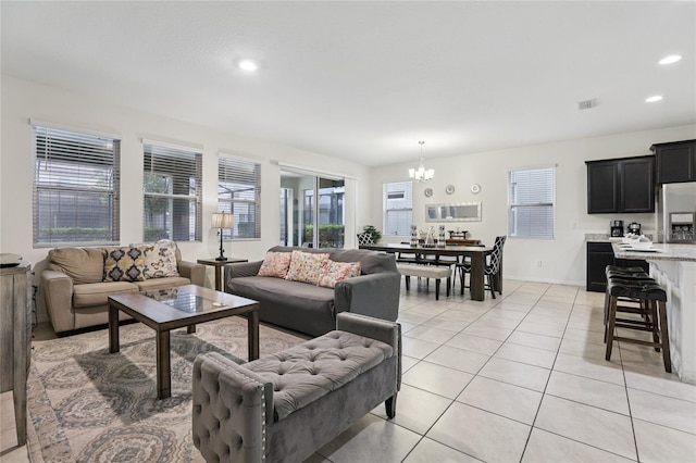 7033 Oakwood St, Davenport, FL 33837 - living area featuring a chandelier, plenty of natural light, light tile patterned floors, recessed lighting, and baseboards