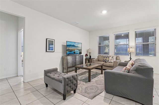 7033 Oakwood St, Davenport, FL 33837 - living room featuring light tile patterned floors and baseboards