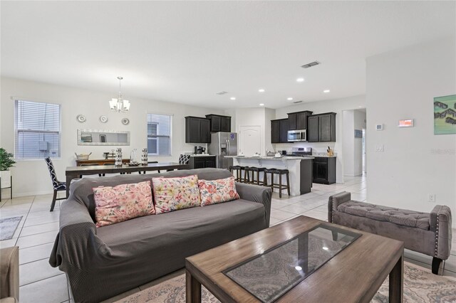 7033 Oakwood St, Davenport, FL 33837 - living room with a chandelier, light tile patterned floors, plenty of natural light, recessed lighting, and baseboards