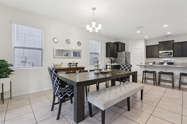 7033 Oakwood St, Davenport, FL 33837 - dining area featuring a chandelier, light tile patterned floors, baseboards, and recessed lighting
