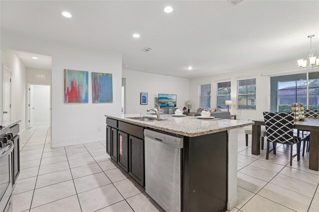 7033 Oakwood St, Davenport, FL 33837 - kitchen featuring stainless steel appliances, a sink, light tile patterned floors, a chandelier, and recessed lighting