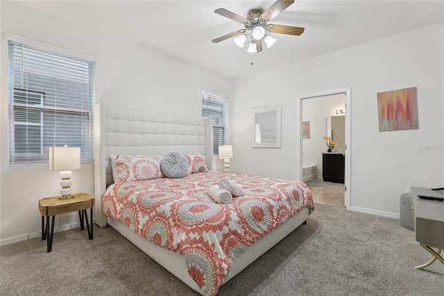 7033 Oakwood St, Davenport, FL 33837 - bedroom featuring carpet flooring, baseboards, ensuite bath, and a ceiling fan