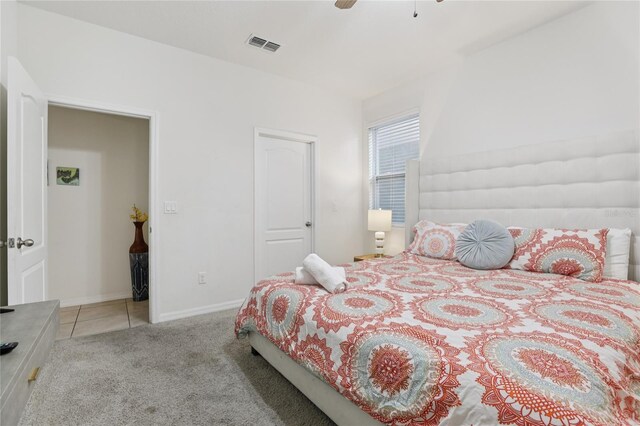 7033 Oakwood St, Davenport, FL 33837 - carpeted bedroom featuring baseboards, ceiling fan, and tile patterned floors