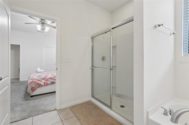 7033 Oakwood St, Davenport, FL 33837 - bathroom with a stall shower, a garden tub, a ceiling fan, tile patterned floors, and ensuite bathroom