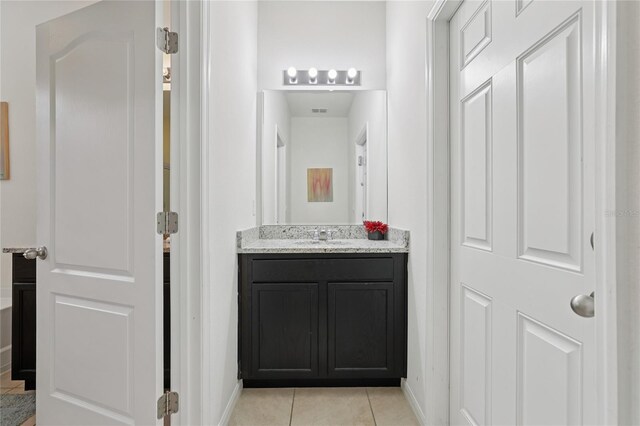 7033 Oakwood St, Davenport, FL 33837 - bathroom featuring tile patterned flooring, vanity, and baseboards