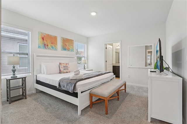 7033 Oakwood St, Davenport, FL 33837 - bedroom with light carpet, baseboards, and ensuite bathroom