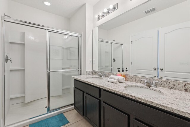 7033 Oakwood St, Davenport, FL 33837 - bathroom with a shower stall, double vanity, and tile patterned flooring